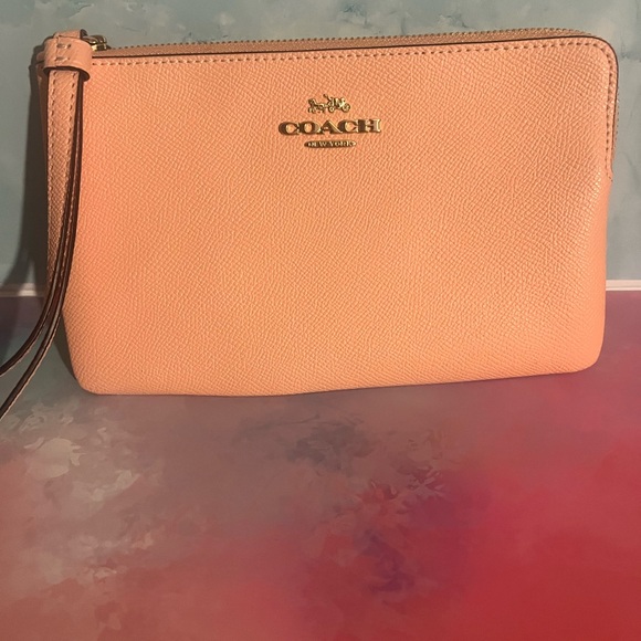 Coach Handbags - Coach Peach Leather Wristlet with Gold Logo